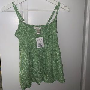 Green tank top with white polkadots. Size M.